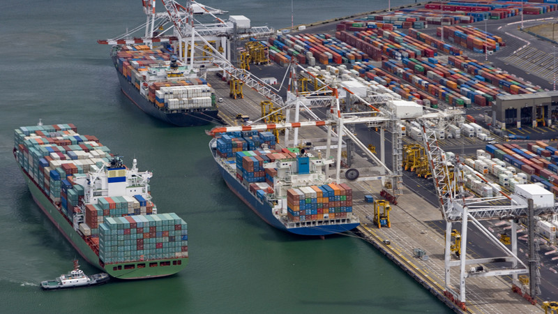 Australia, Melbourne, container ship preparing to berth, aerial view